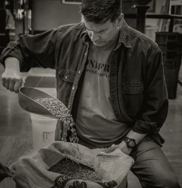 Founder Tim inspecting coffee beans