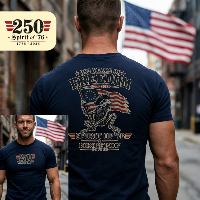 Man wearing a navy blue t-shirt with '250 Years of Freedom' design, standing in front of an American flag.